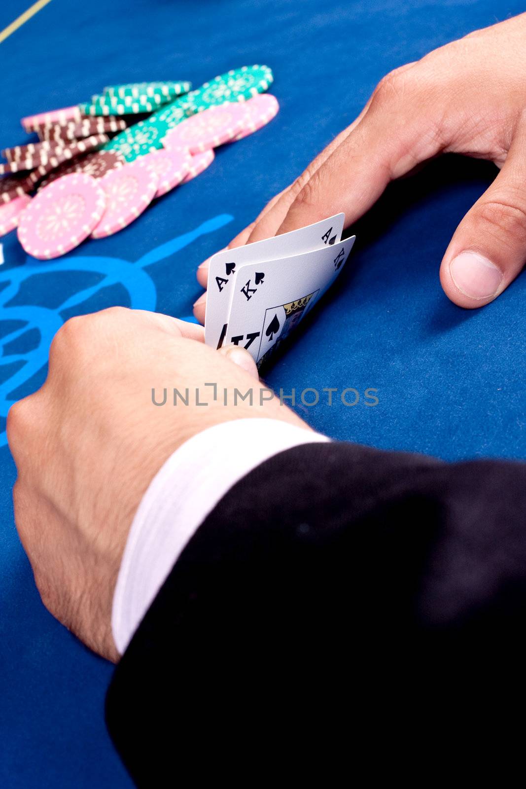 hands of a man with a card for the poker table