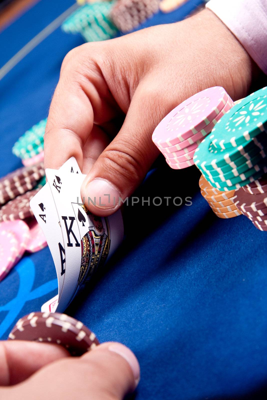 hands of a man with a card for the poker table