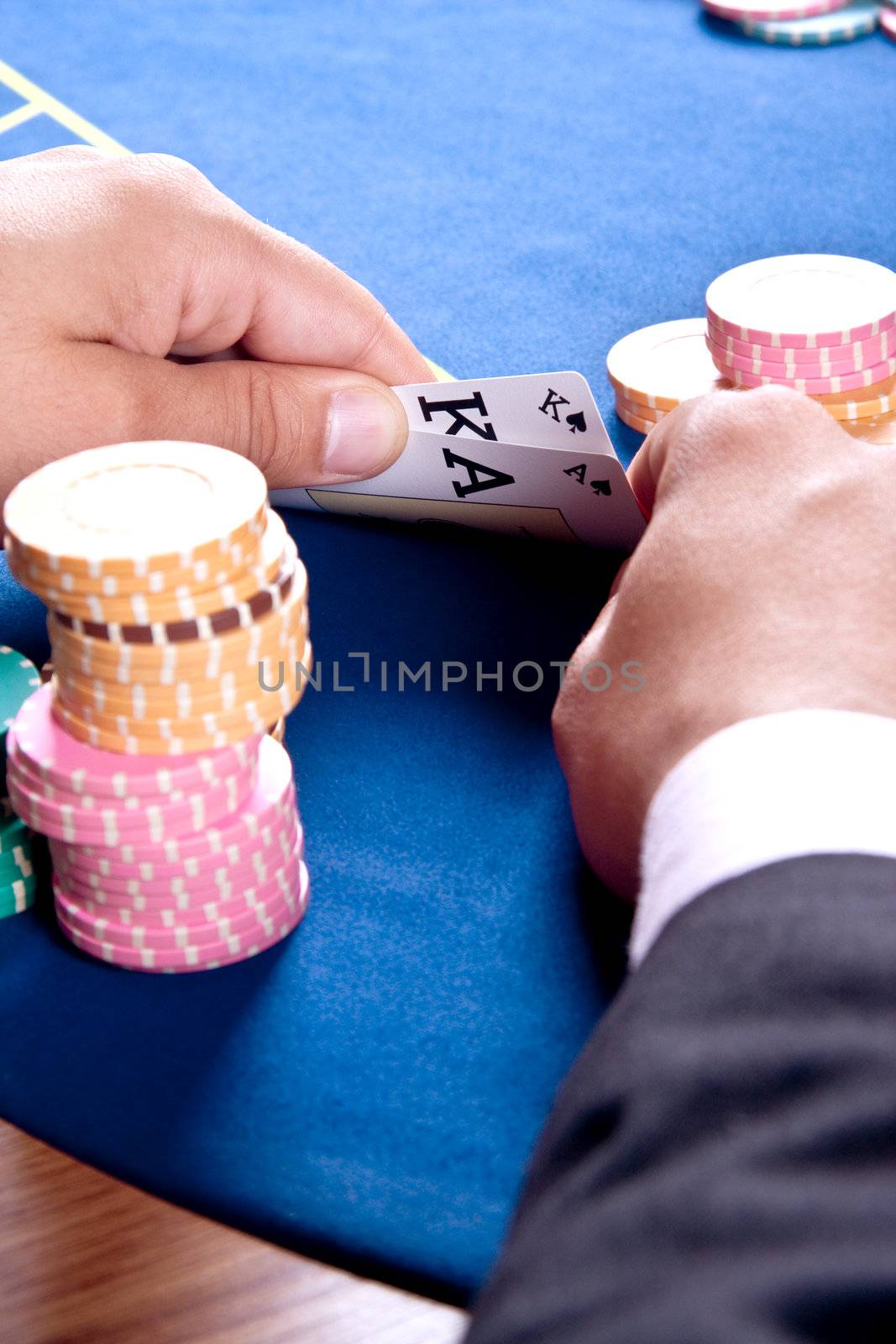 hands of a man with a card for the poker table