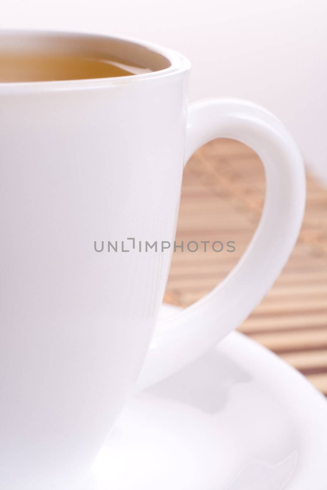 a white cup of tea standing on the table