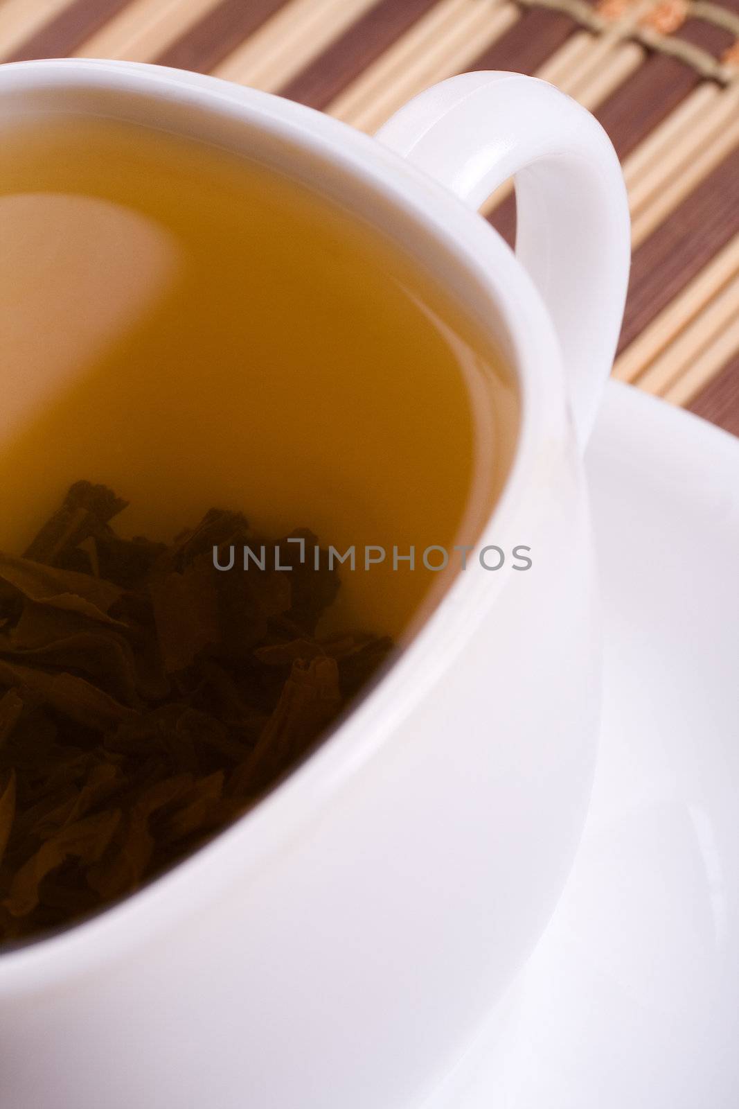 a white cup of tea standing on the table