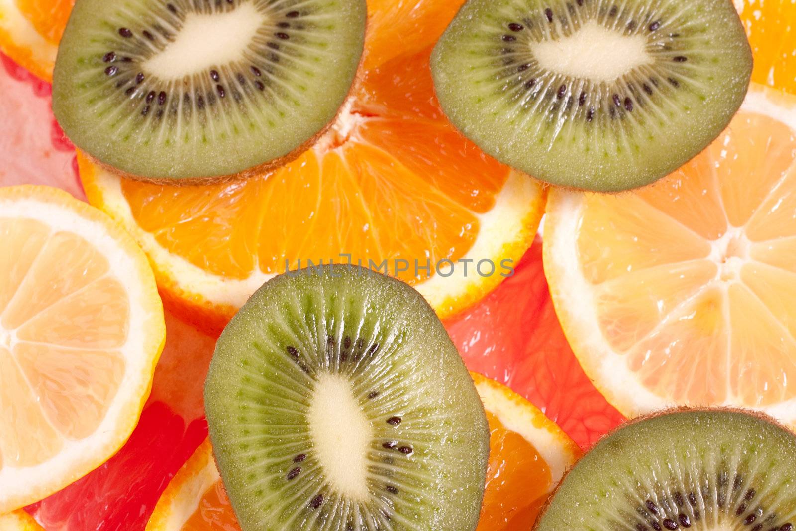 assorted fruits of apple, grapefruit, orange, lemon and kiwi as a background