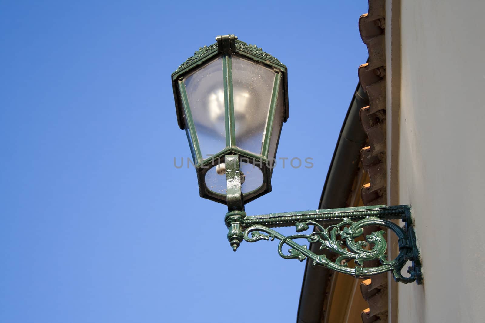 the lantern on the wall in the historic location in Prague