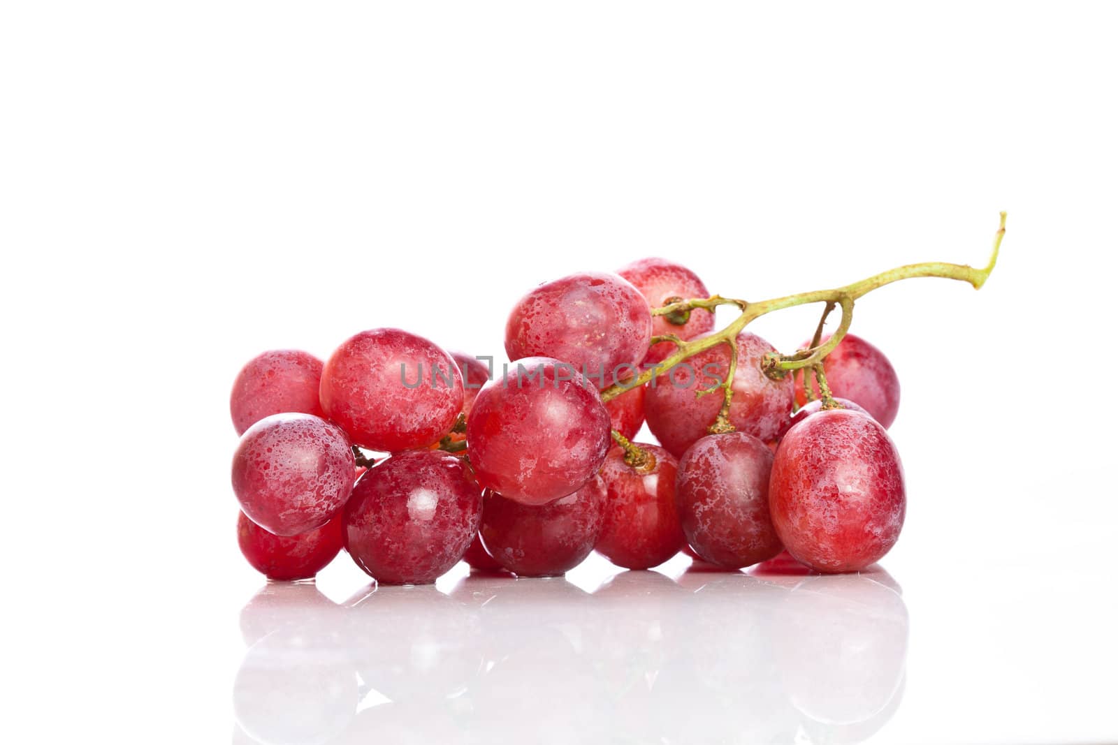 Fresh red grapes on white background