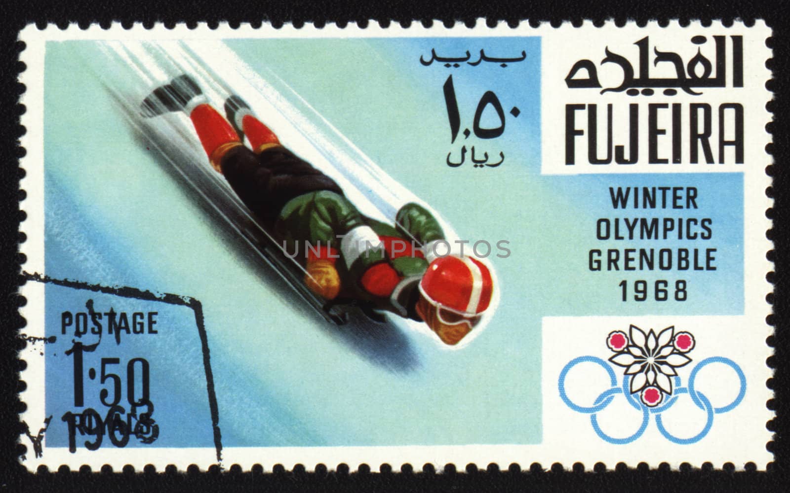 Postage stamp from Fujeira shows Winter Olympic Games in Grenoble 1968. Descent to sledge