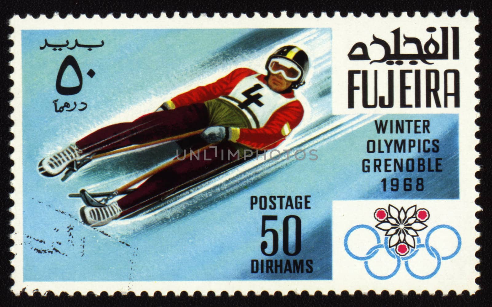 Postage stamp from Fujeira shows Winter Olympic Games in Grenoble 1968. Descent to sledge