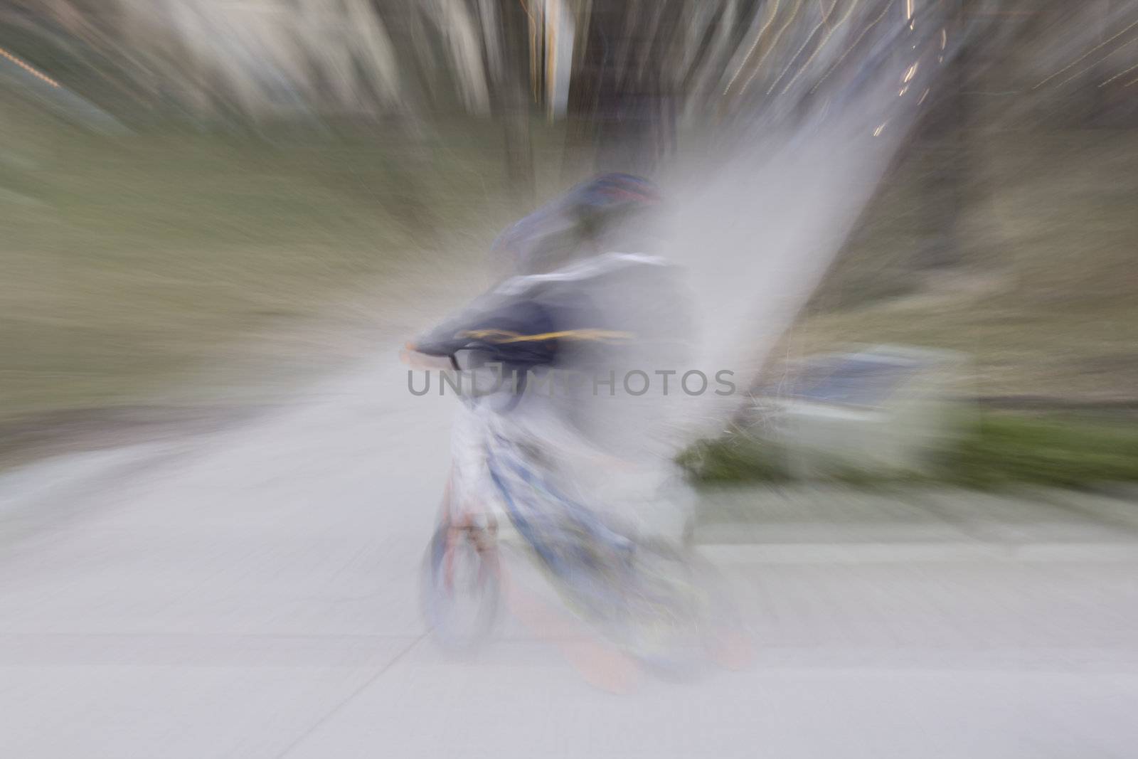 A young boy riding his mountain bike wrapped with light 