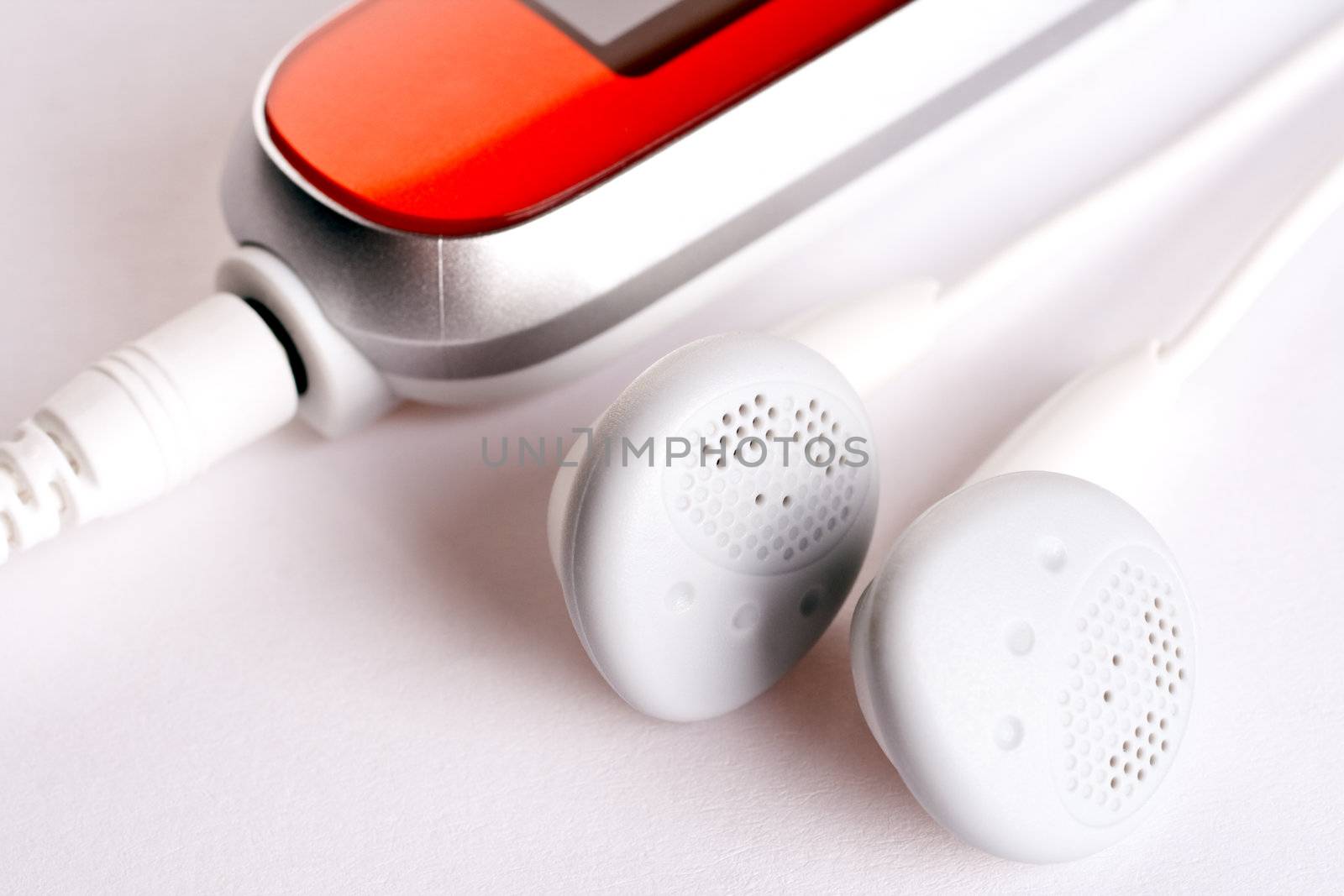 mp3 player with headphoneson on a white background