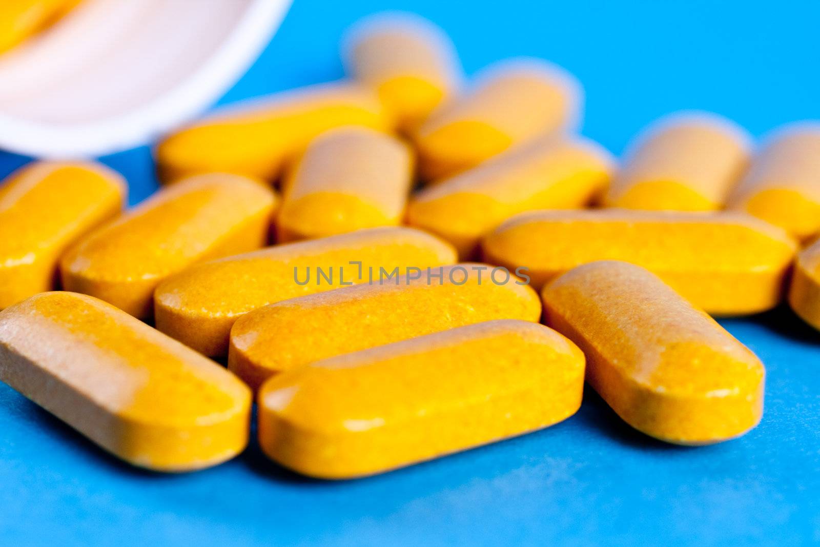 supplements in pill form on a blue background