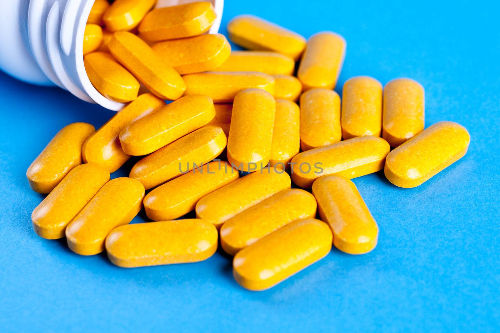 supplements in pill form on a blue background