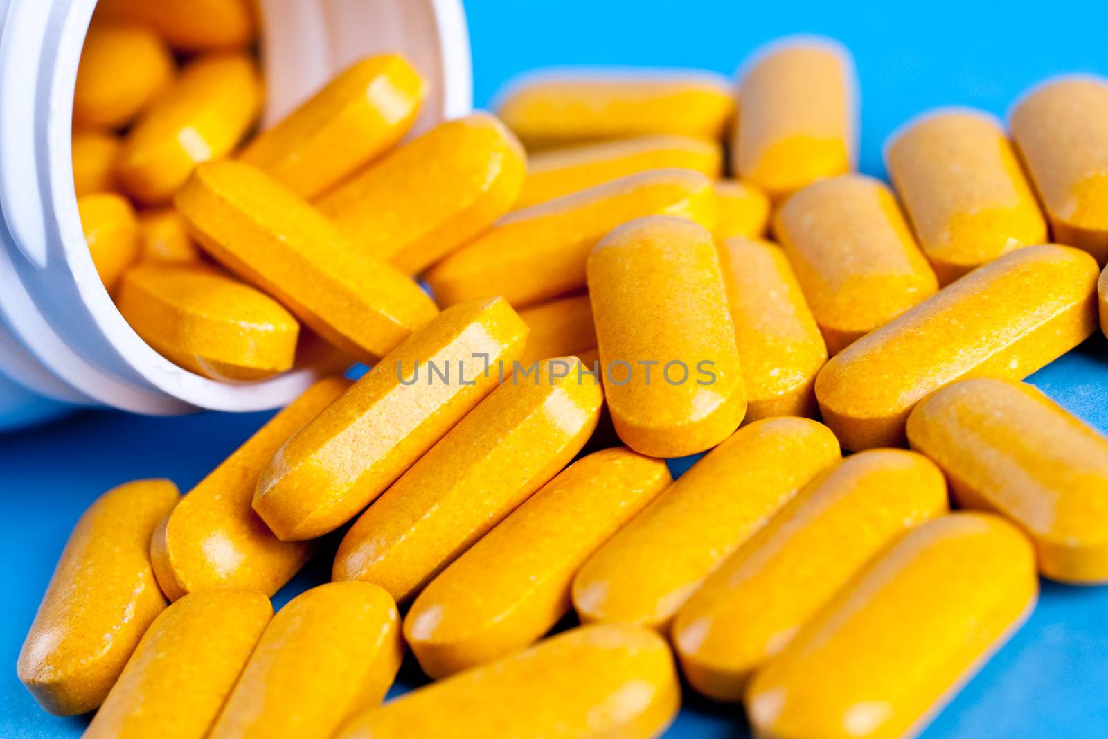 supplements in pill form on a blue background