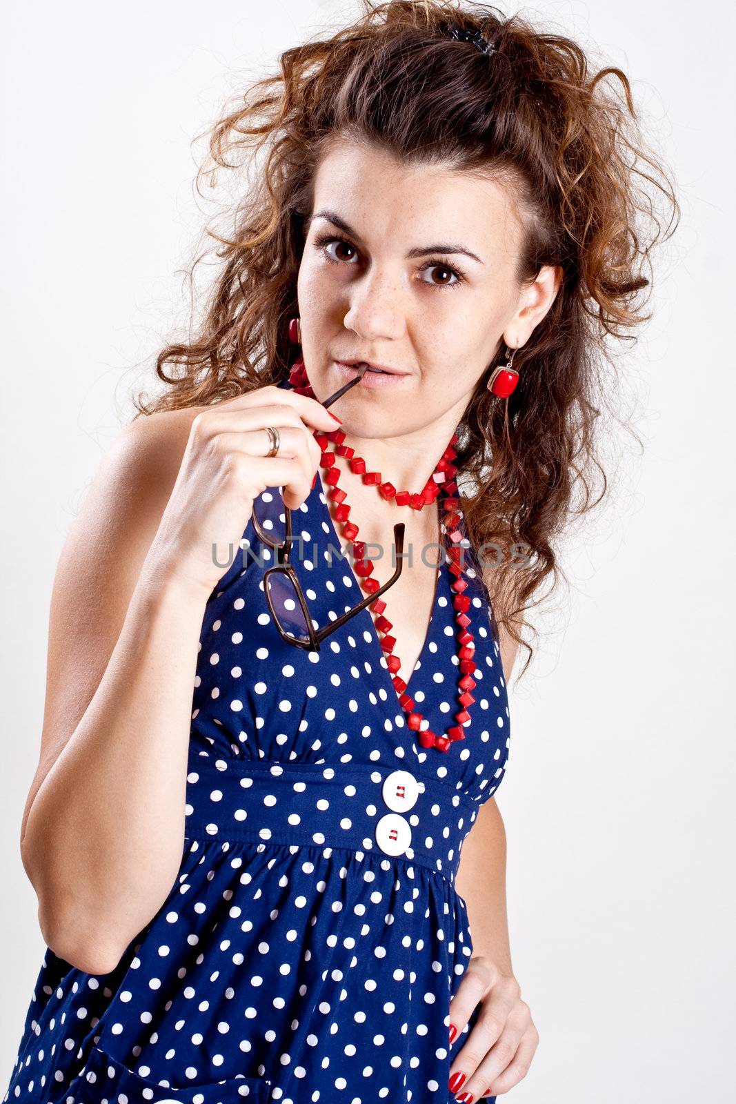 beautiful woman in a blue polka dot dress with glasses