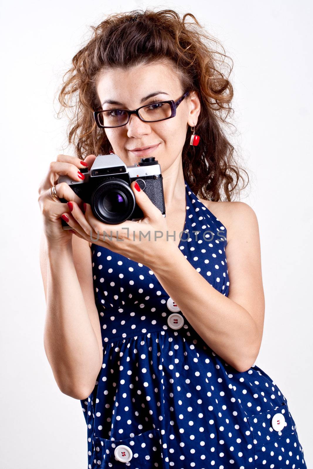beautiful woman in a blue polka dot dress with camera