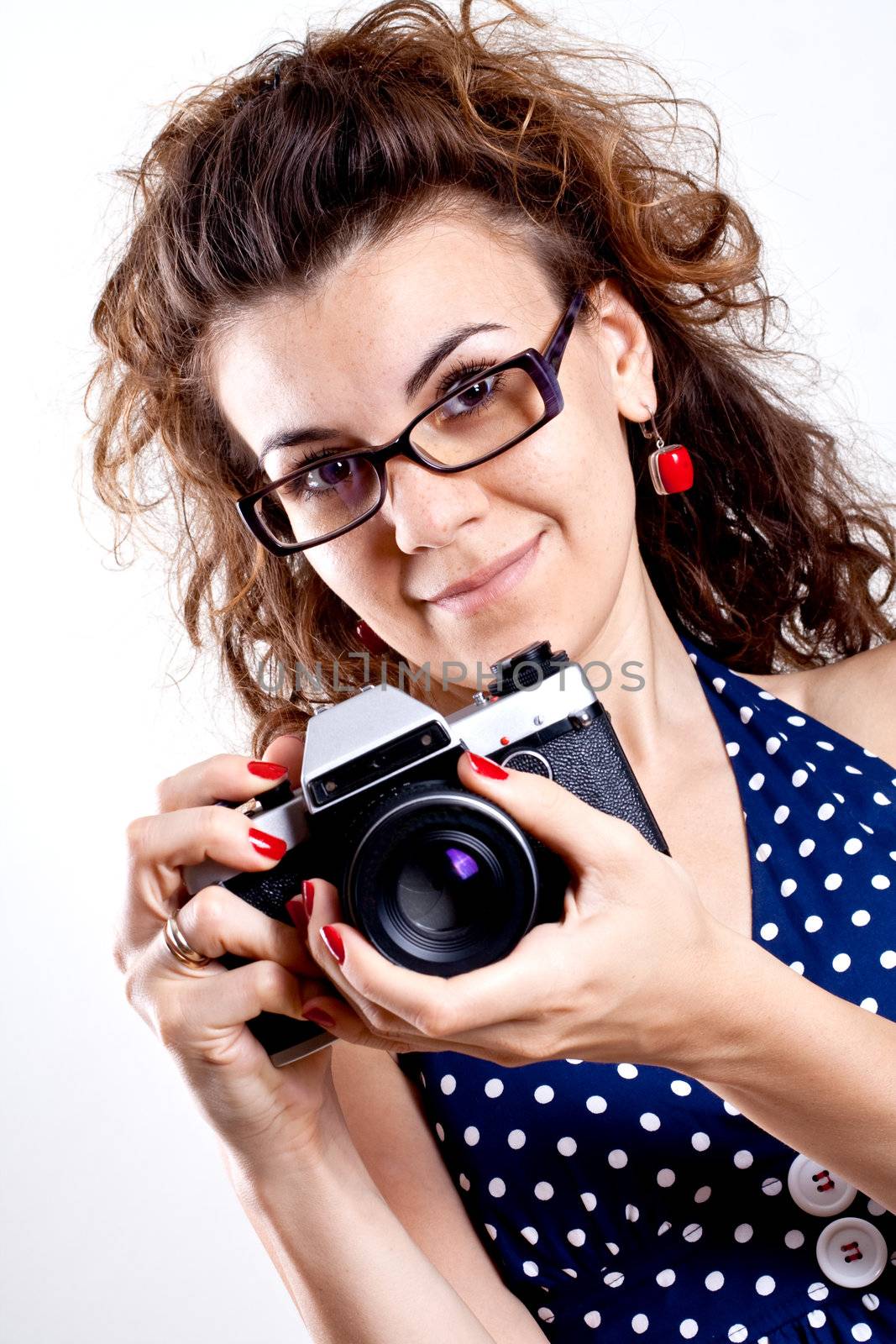 beautiful woman in a blue polka dot dress with camera by Lupen