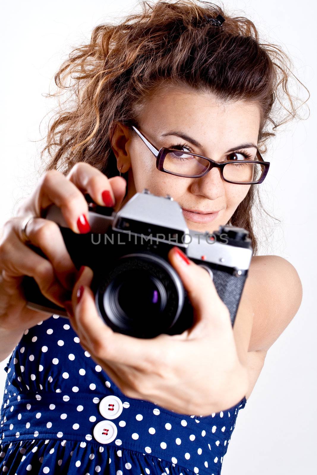 beautiful woman in a blue polka dot dress with camera by Lupen
