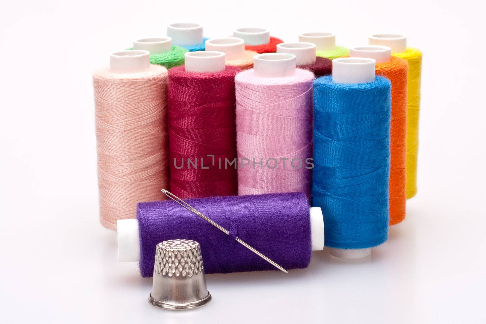 multi-colored rainbow threads for sewing with needle and thimble 
