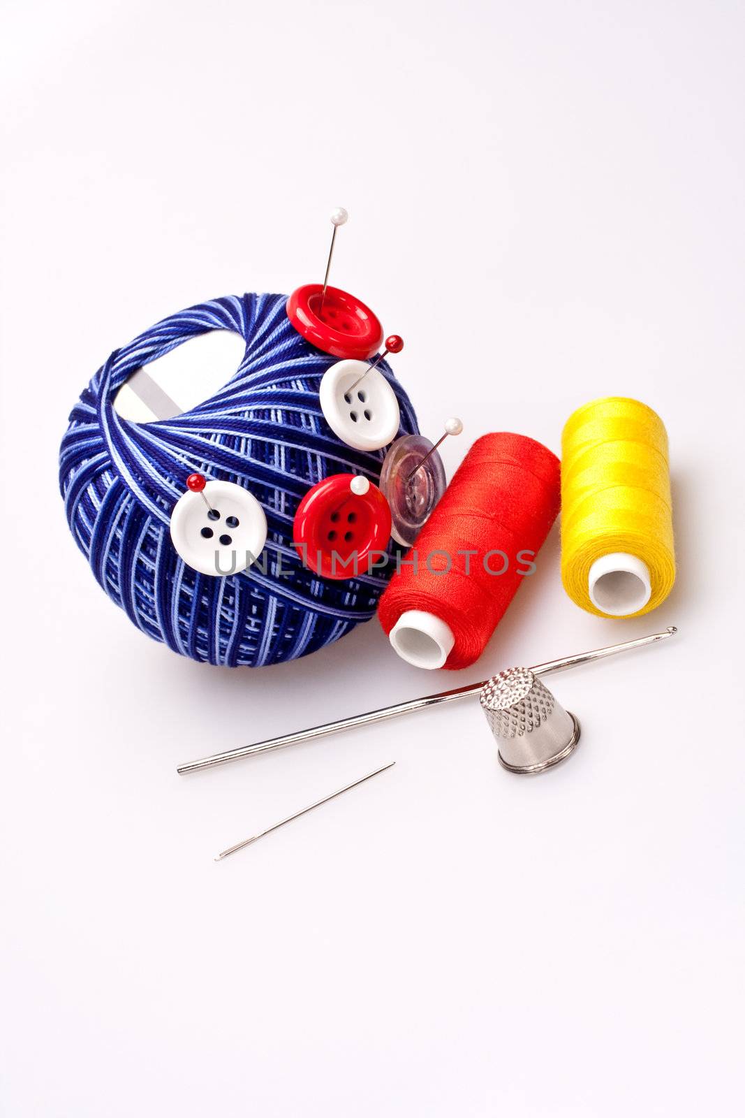 pins in wool ball with buttons by Lupen