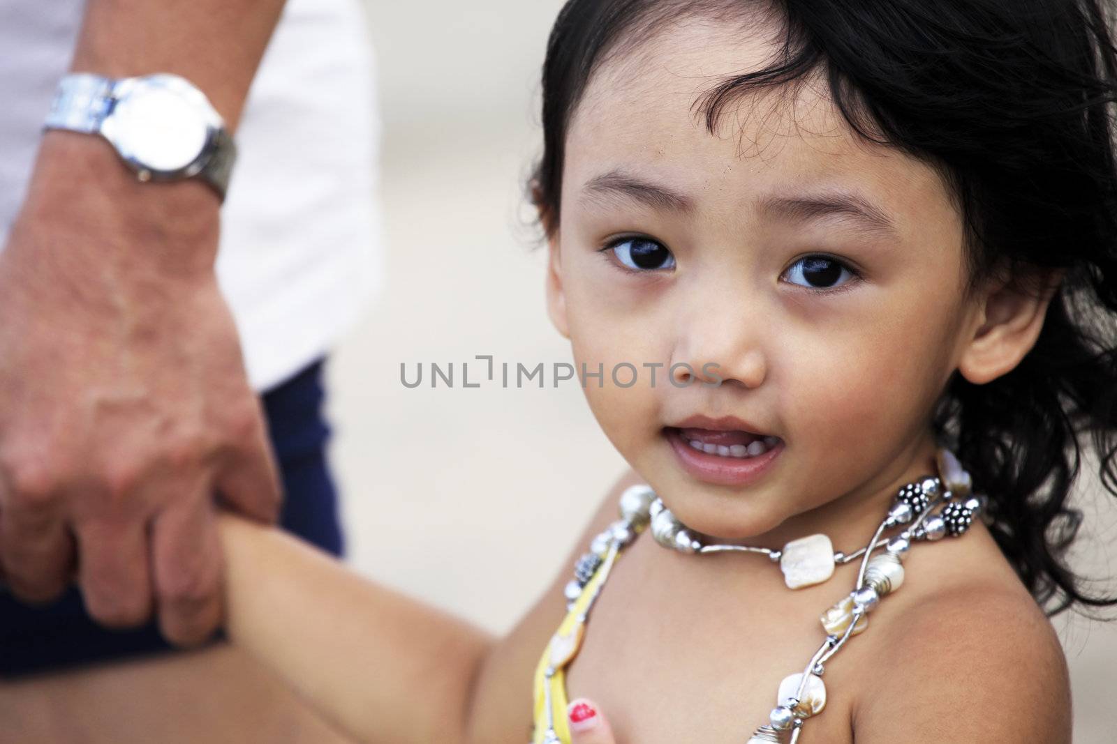 Portrait of the beautiful small Asian girl with father. Indonesia. Java