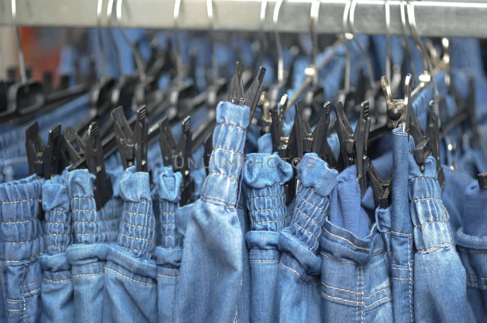 Row of jeans trousers on sell