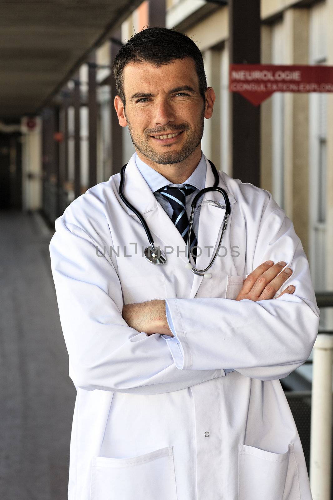young doctor in front of hospital entry