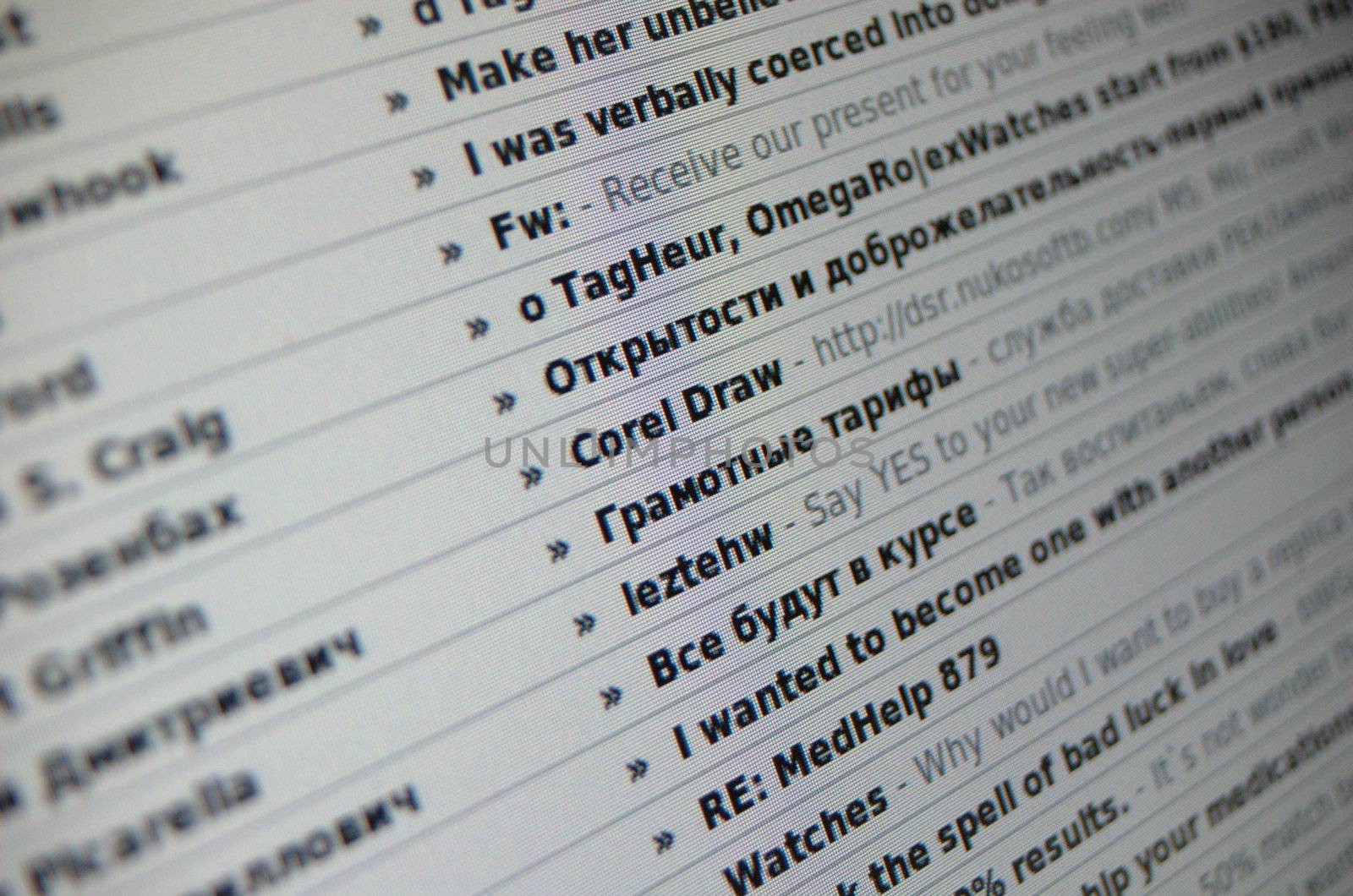 Close-up shot of a list of spam emails, on a computer display, with short depth of field. The center of focus is on the beginnings of the subject lines. Subjects are in both English and Russian. Could be used for any article relating to email, spam, or computer security.