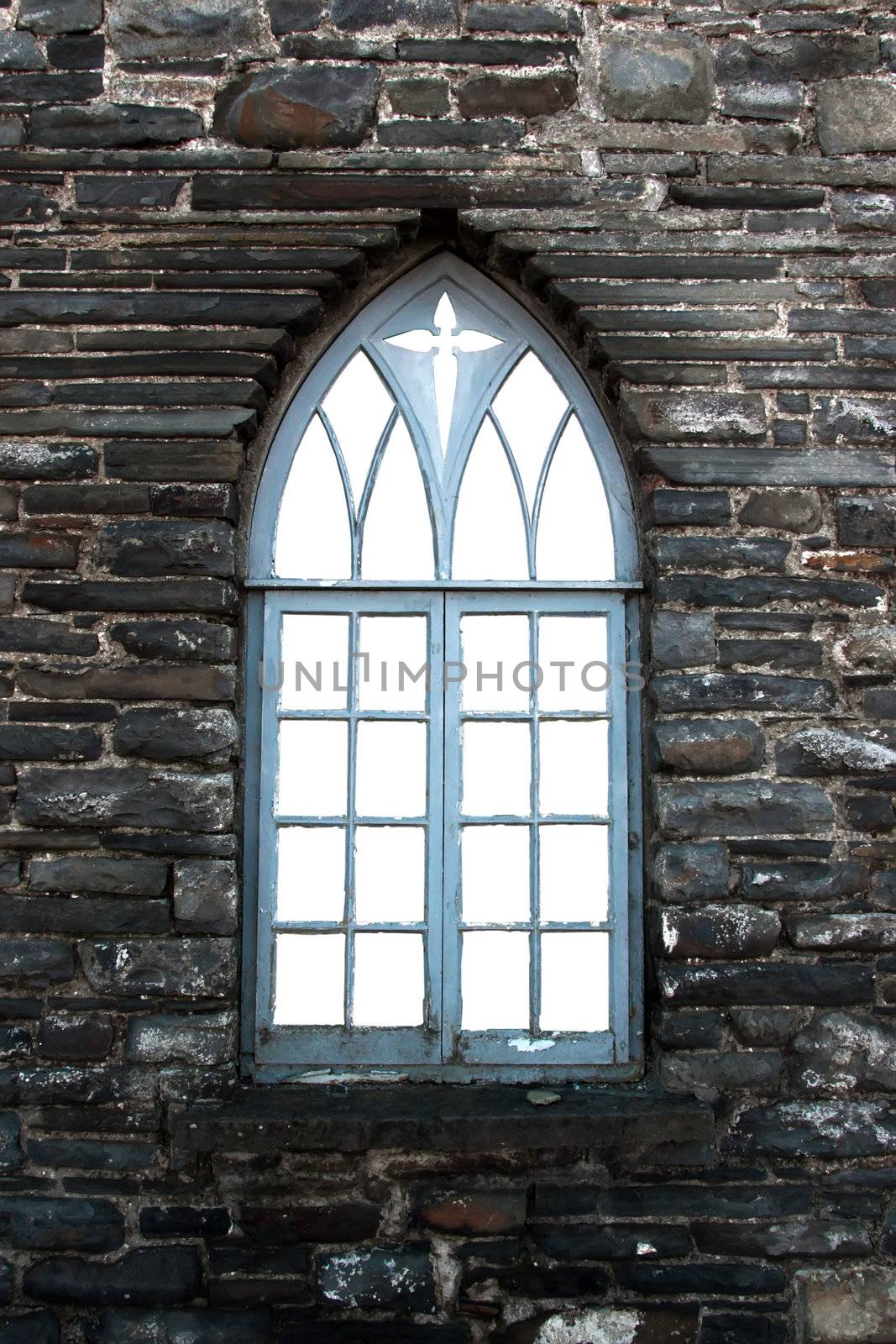 an old castle arch shaped window against a stone wall