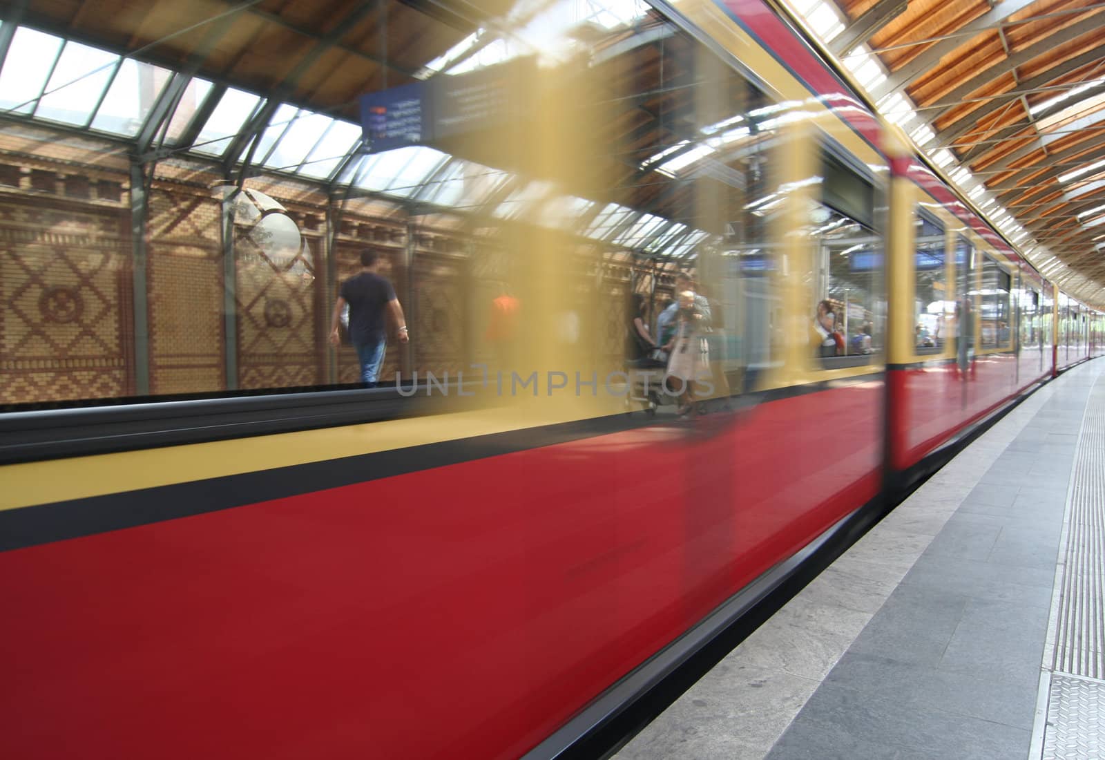 Berlin subway platform with passengers reflection
