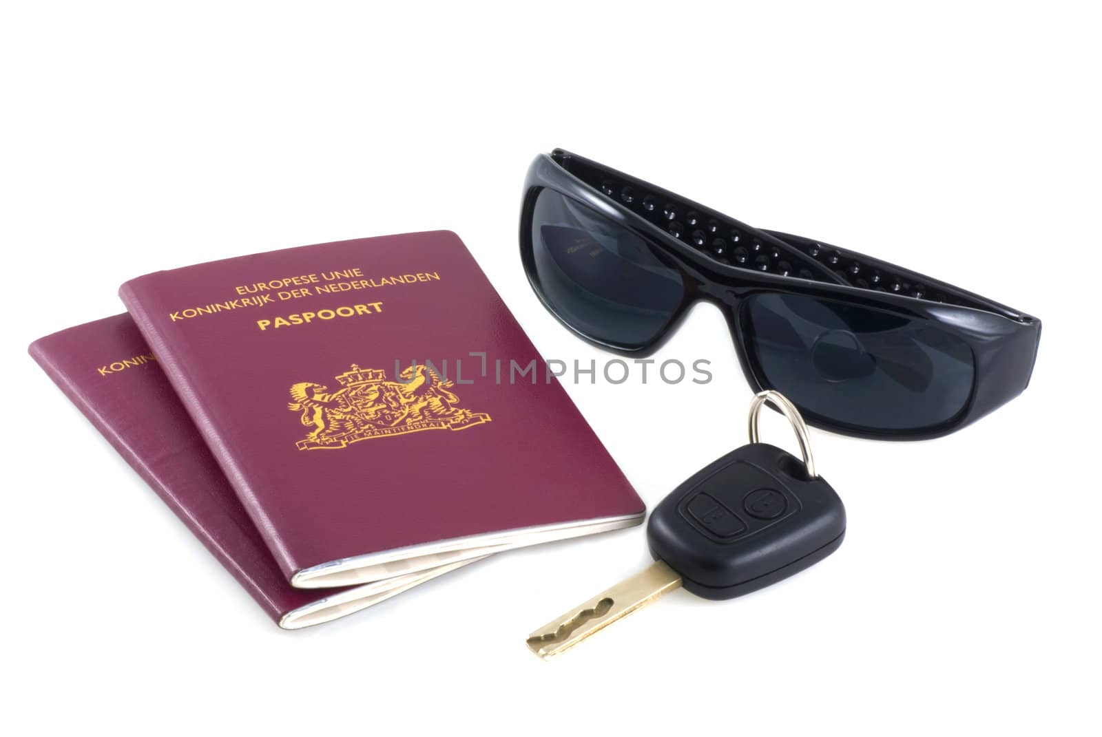 Passports, shades and a car-key on a white background.