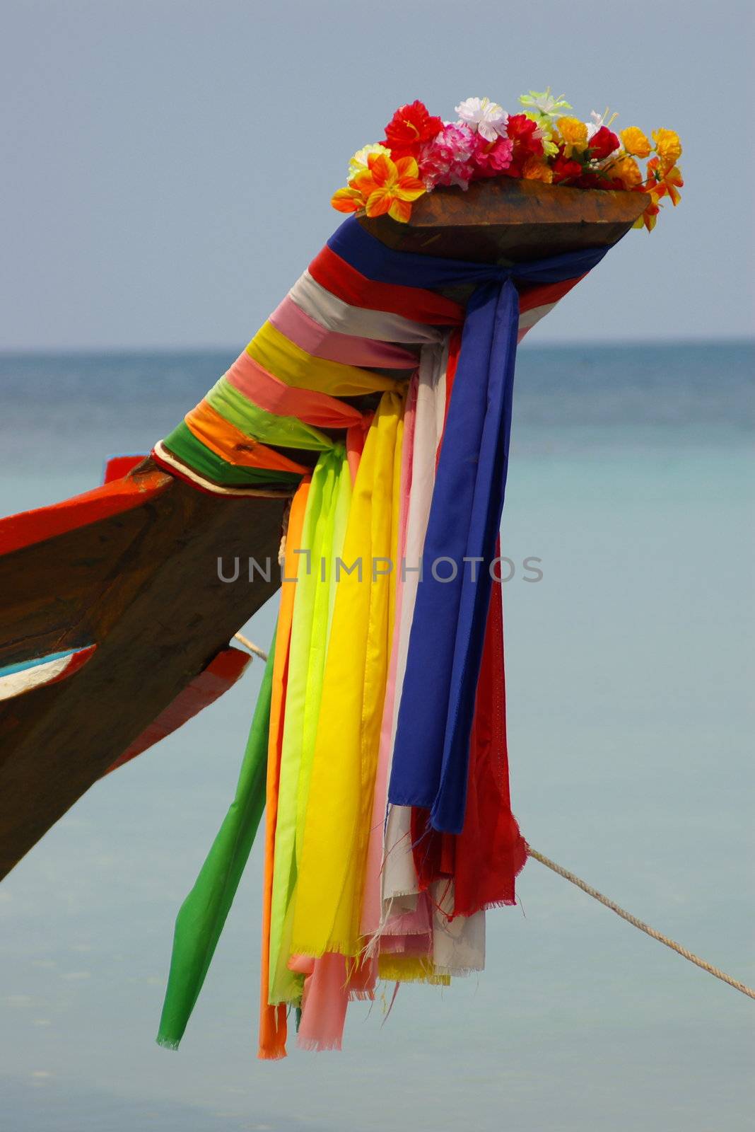 Longtail boat with colored prayer flags