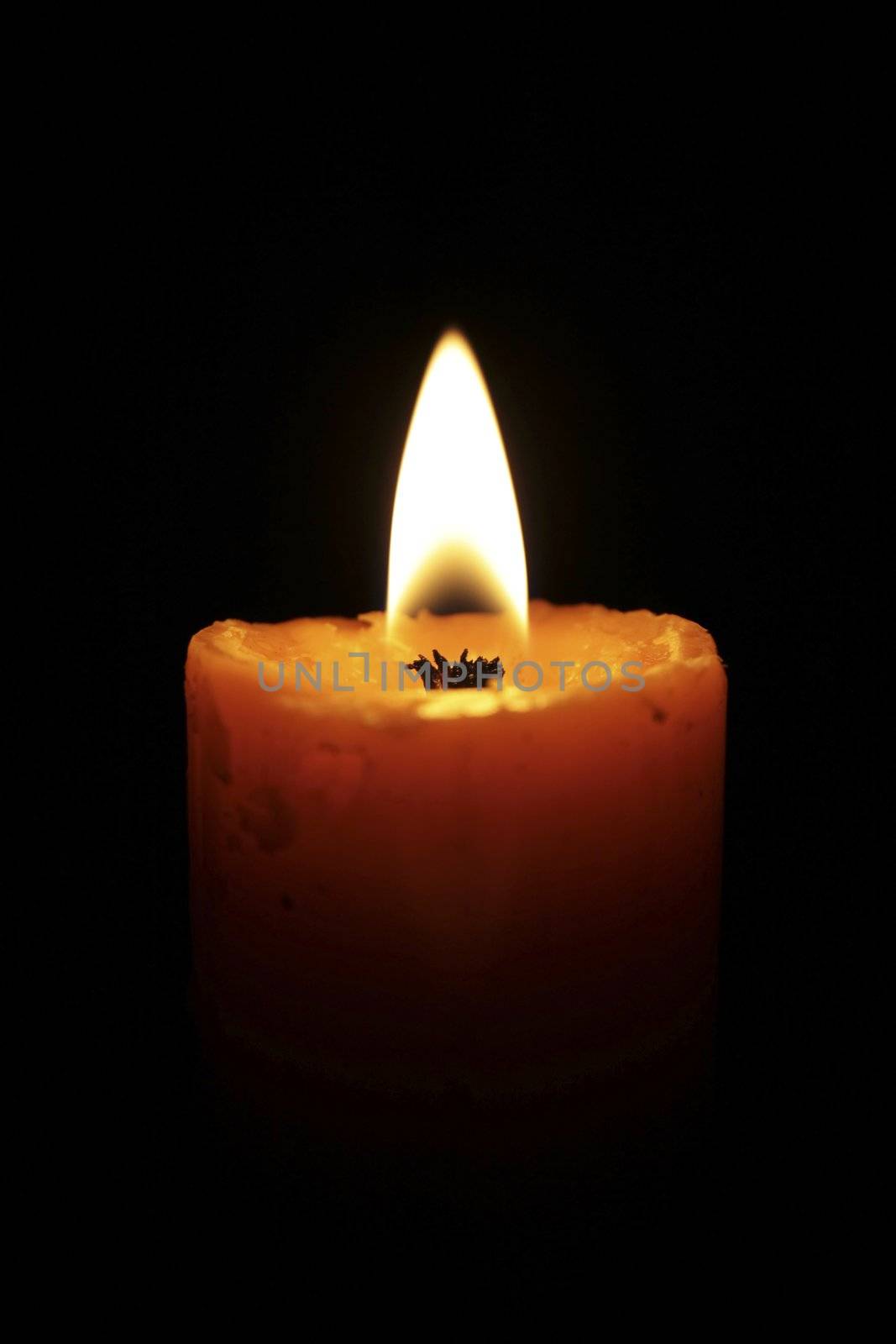 Burning candle in the dark