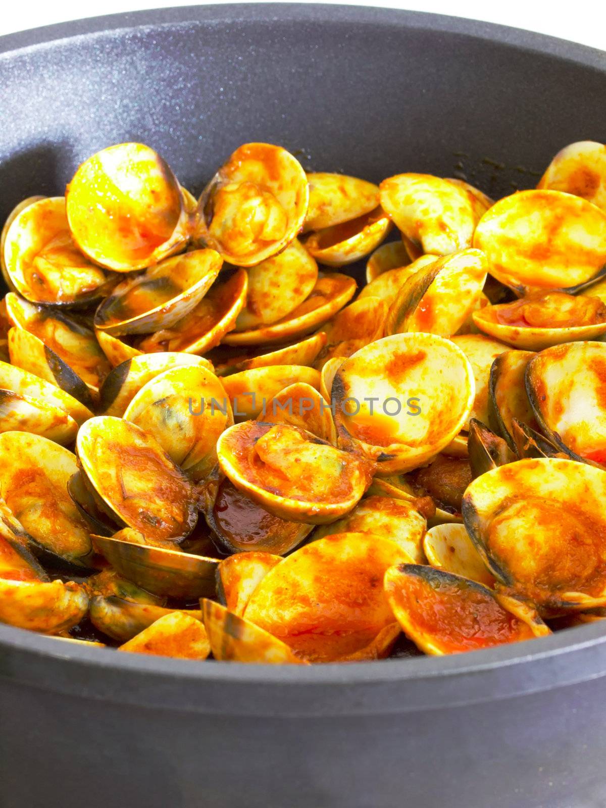 close up of clams in chili sauce