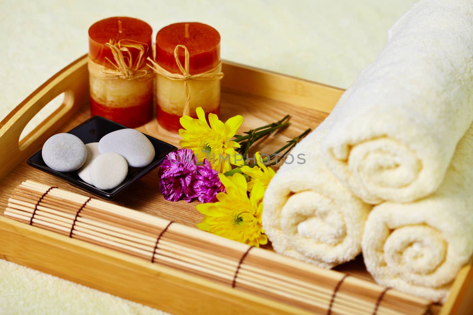 Still life on the spa. A tray of towels, candles and pebbles