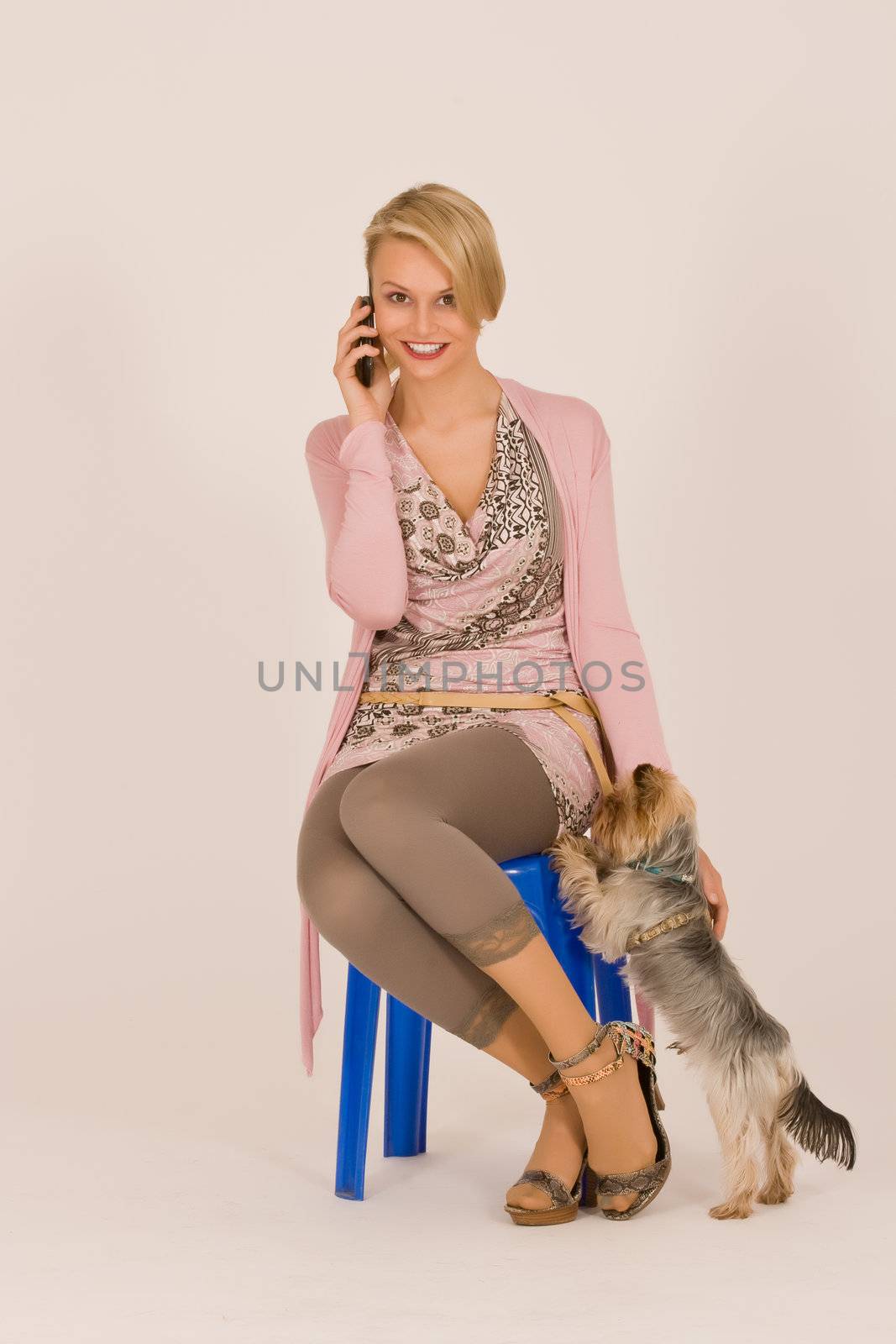 Young woman phoning with a cell phone with the dog