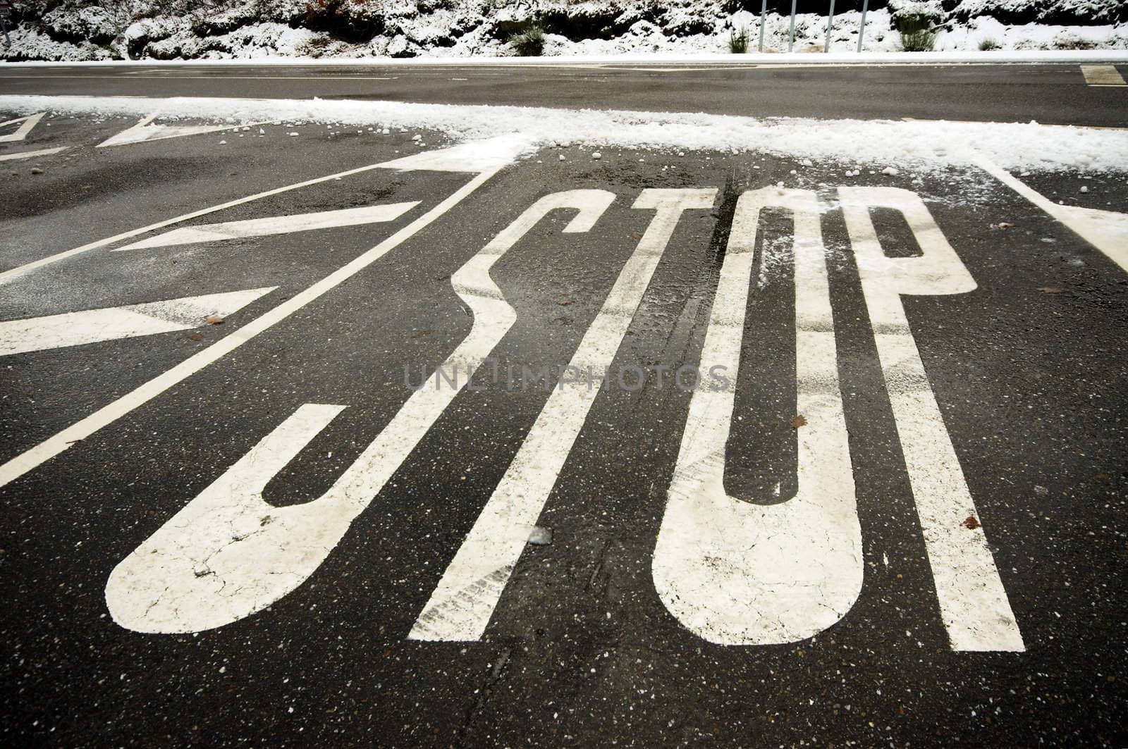 Painted STOP indication at snowy road