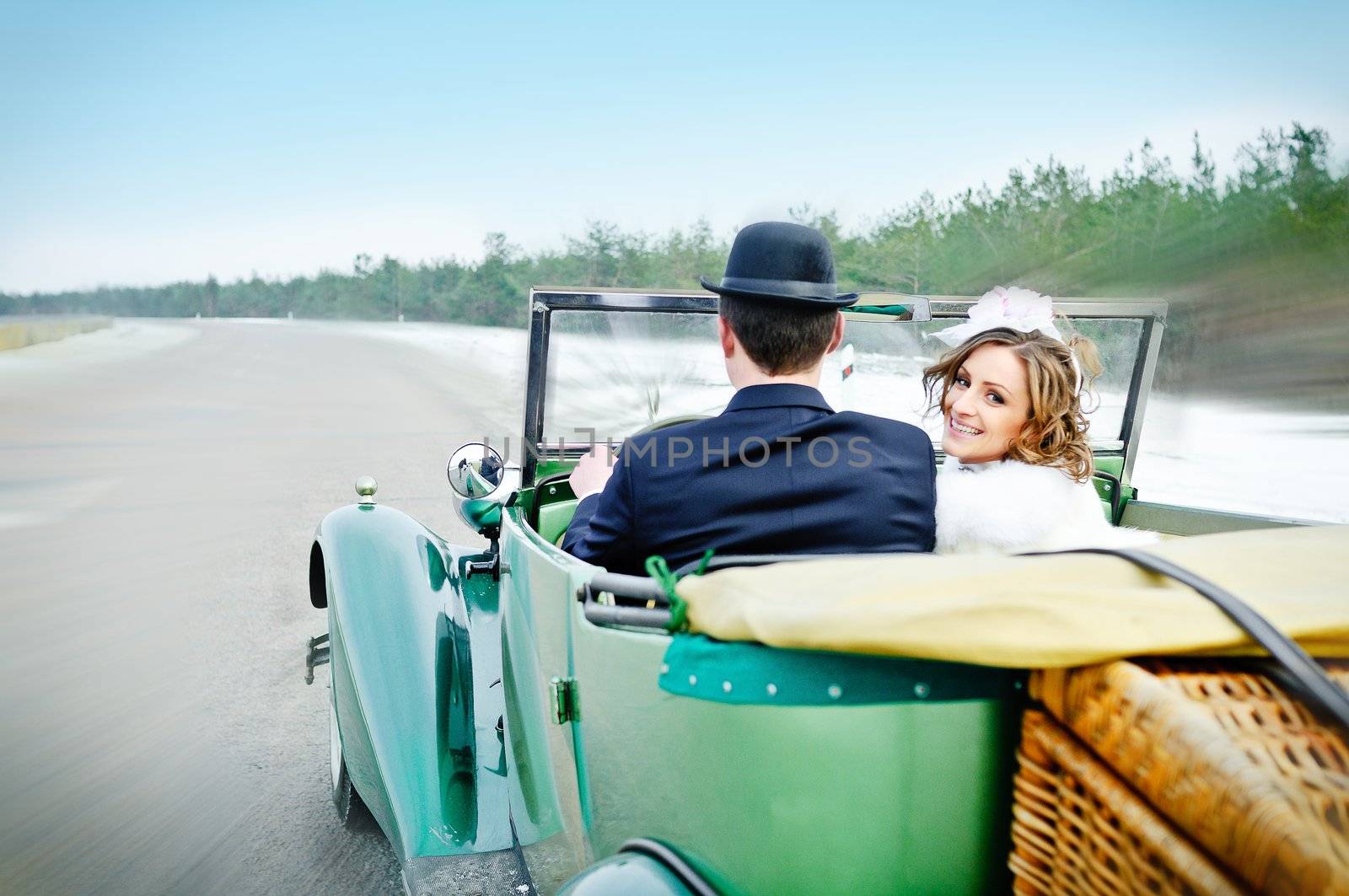 the newly married couple drive retro wedding car