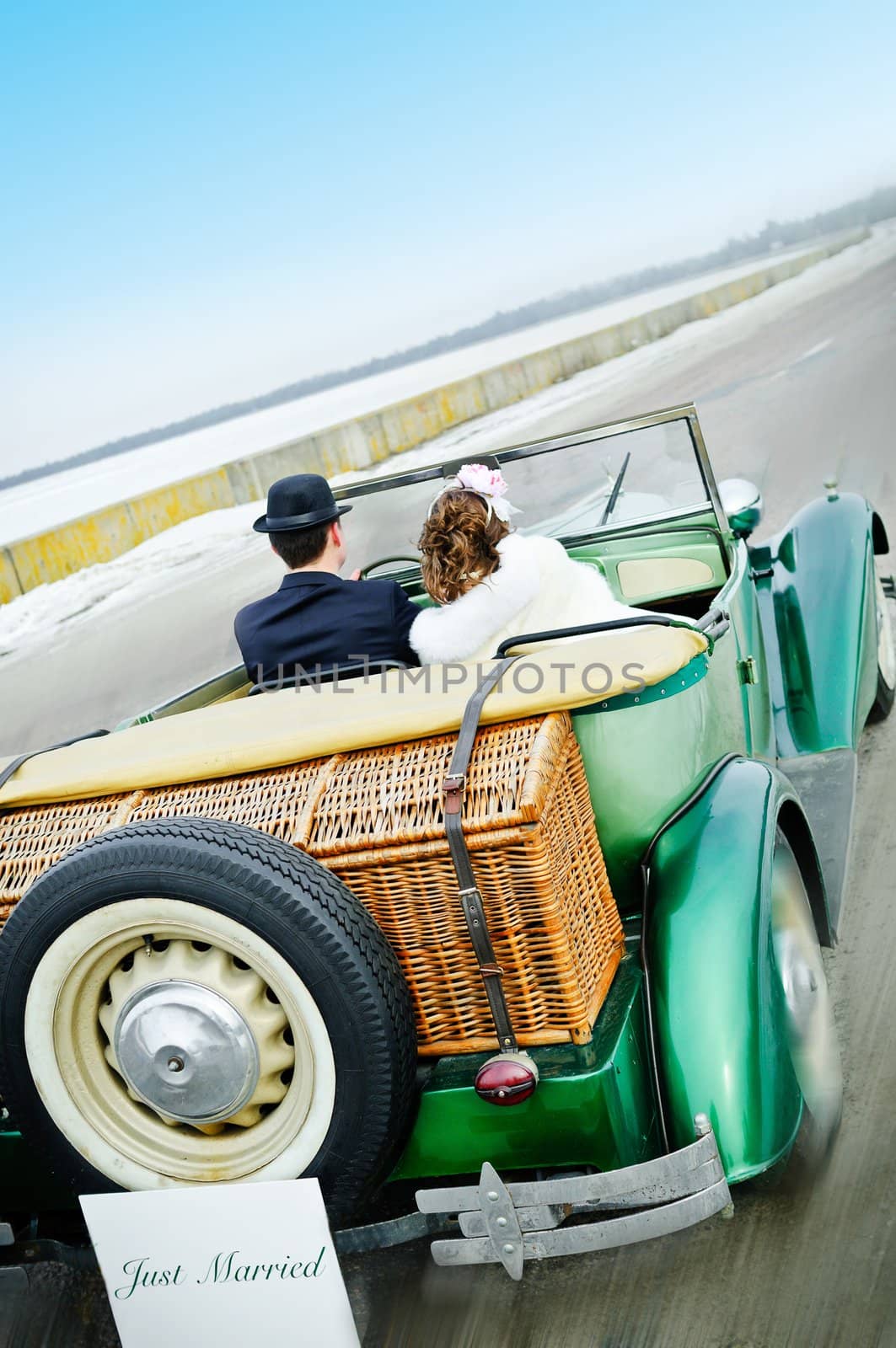 the newly married couple drive retro wedding car