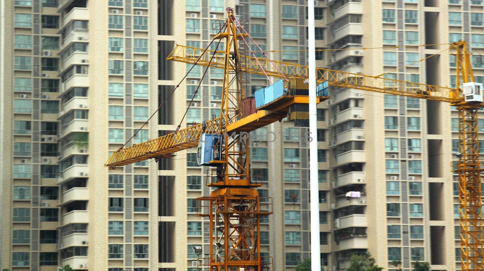 Building of a skyscraper with two tower cranes 