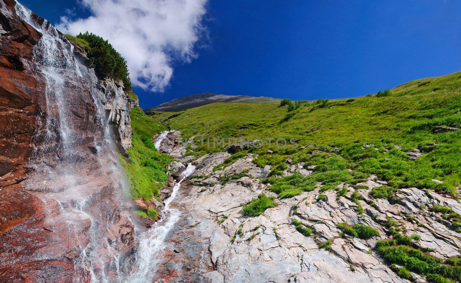 A waterfall in the Alps, Austria by maxoliki