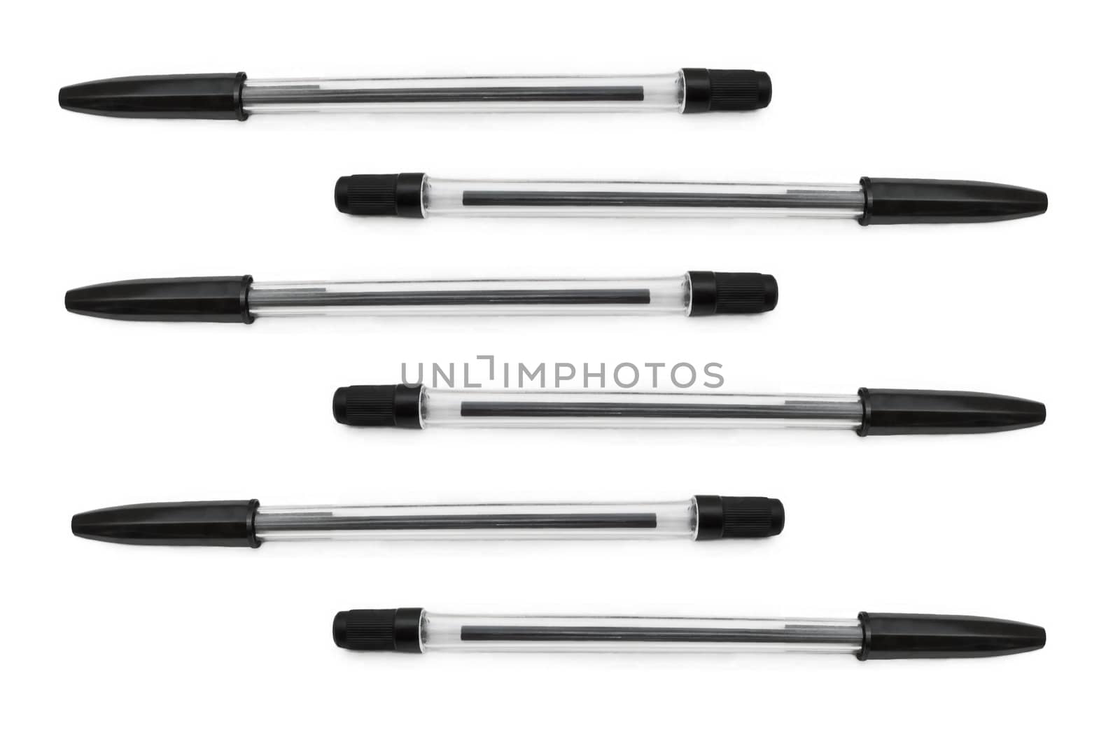 Six black biro pens arranged horizontally in formation over white