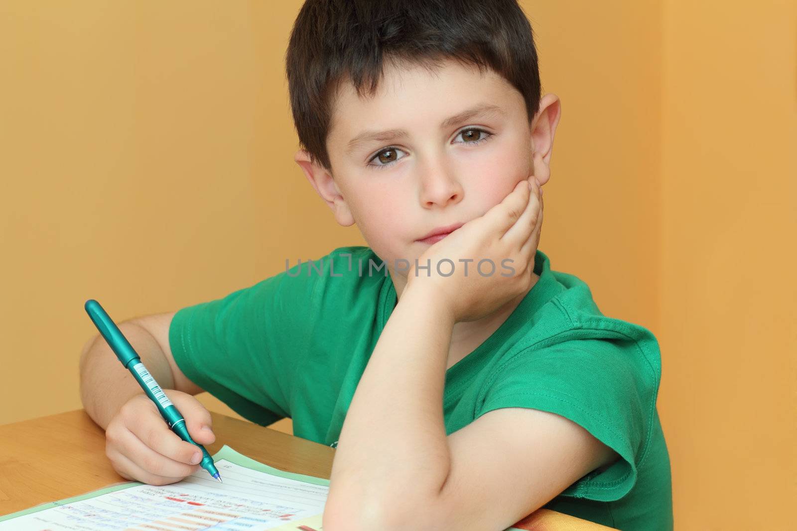 boy doing homework from school in workbook