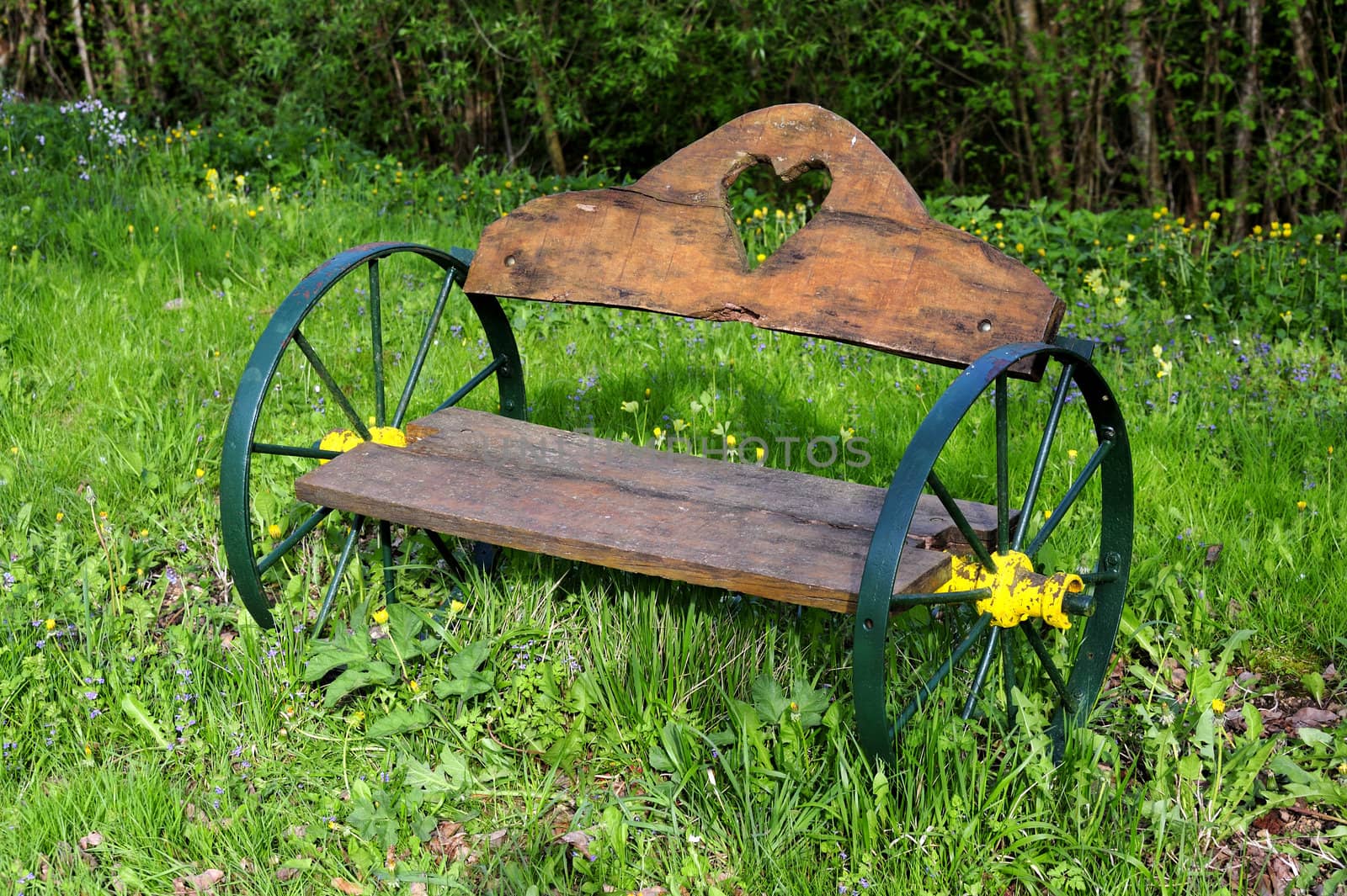 An unusual bench, with wheels instead of legs, beside a canal in France
