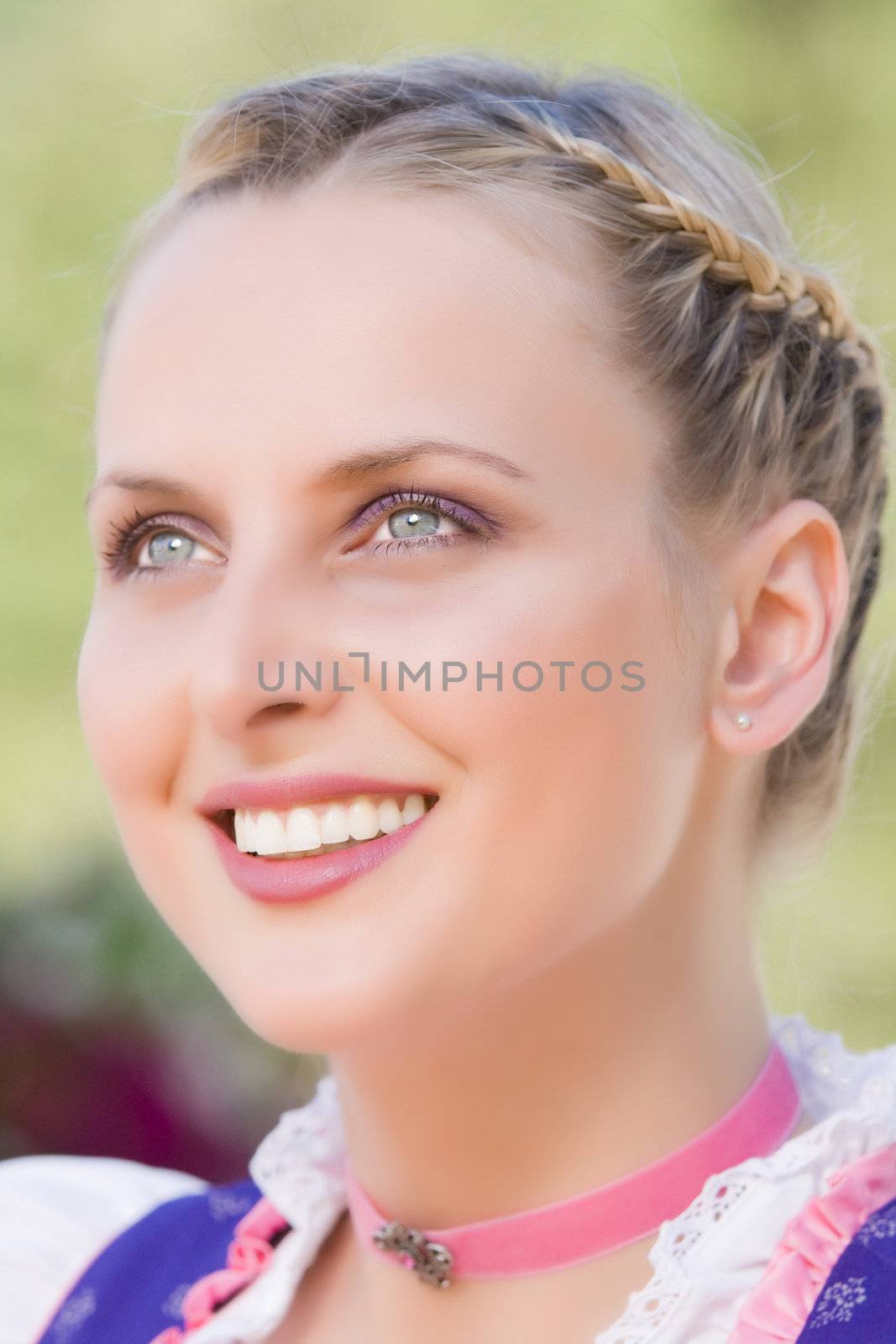 Portrait of a young woman with traditional hairstyle Bavarian Dirndl