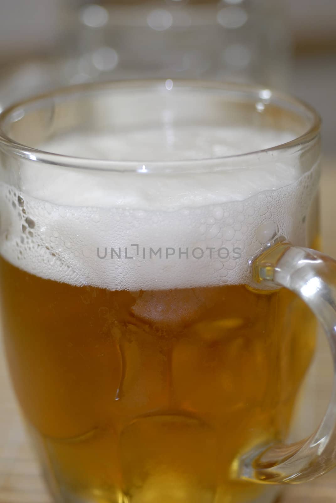 isolated shot of beer poured in a glass from a bottle