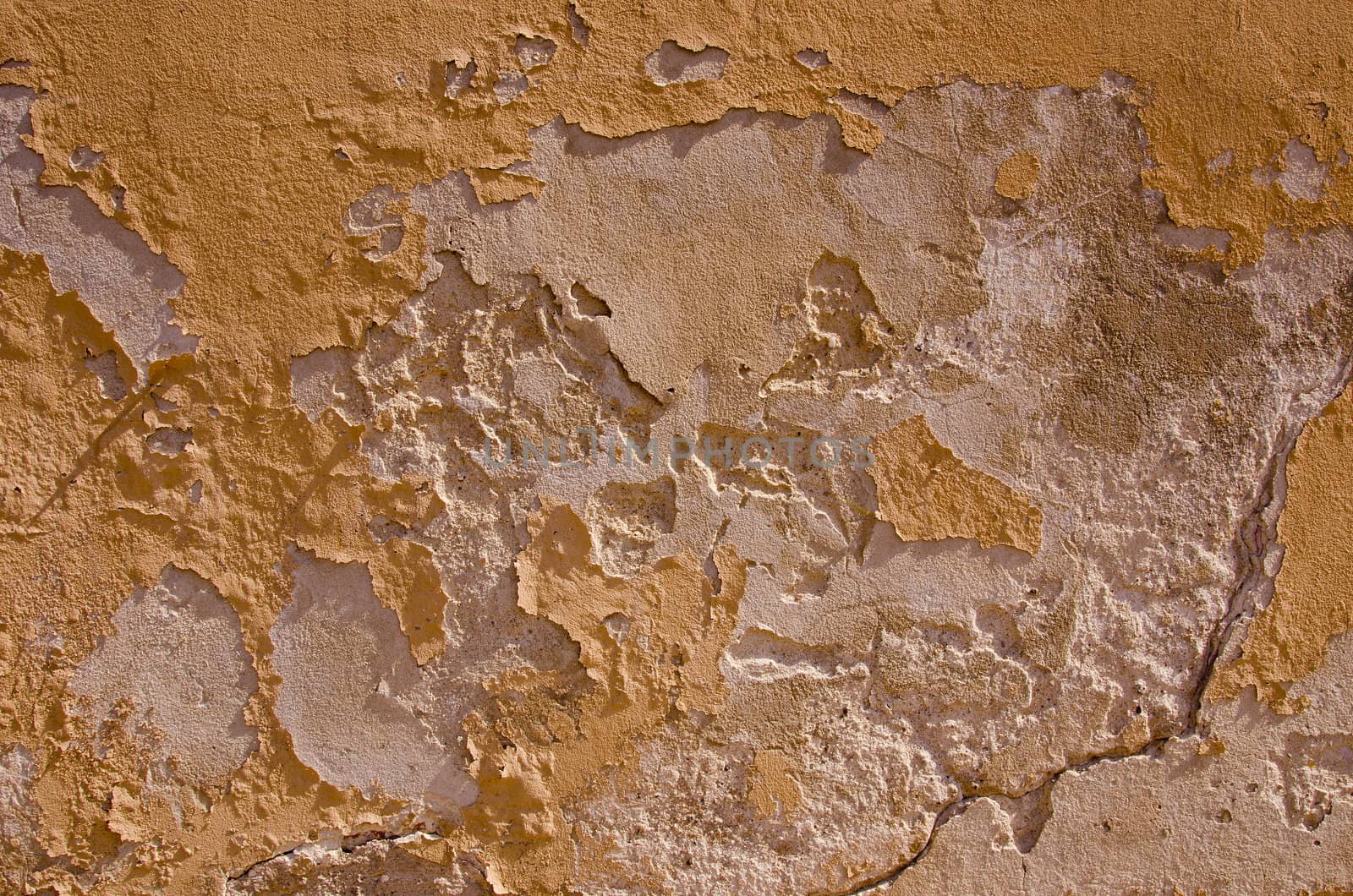 Old breaking down wall. Fragment of an abandoned building background.