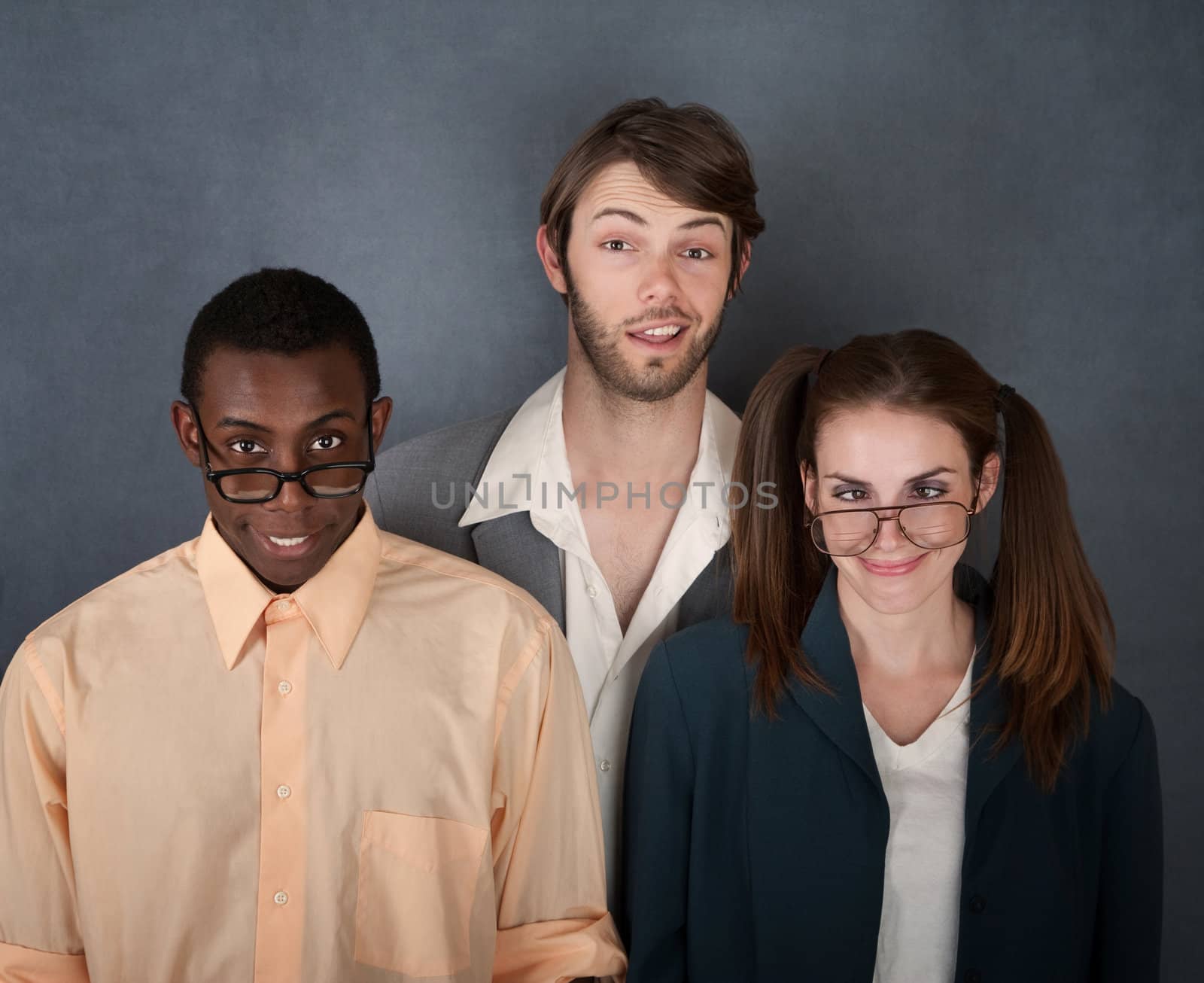 Mixed group of geeks on gray background smiling