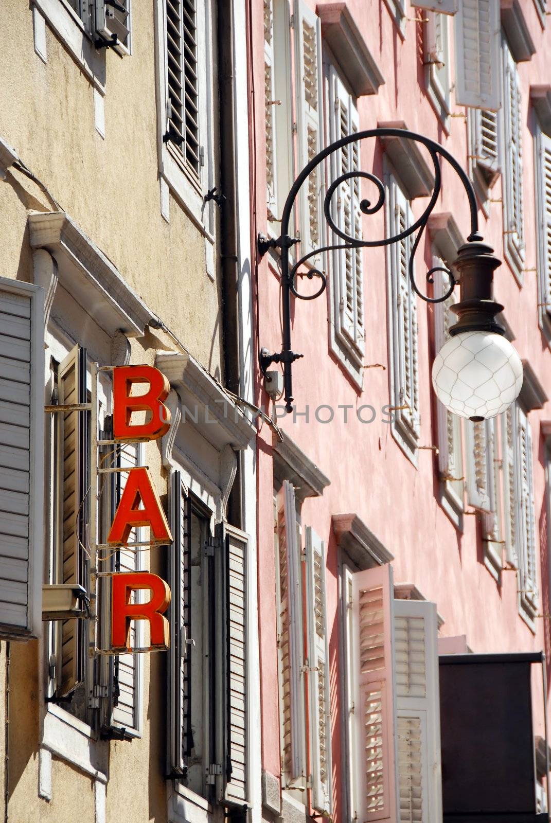 architecture detail, street lamp and bar sign  in Trieste, Italy