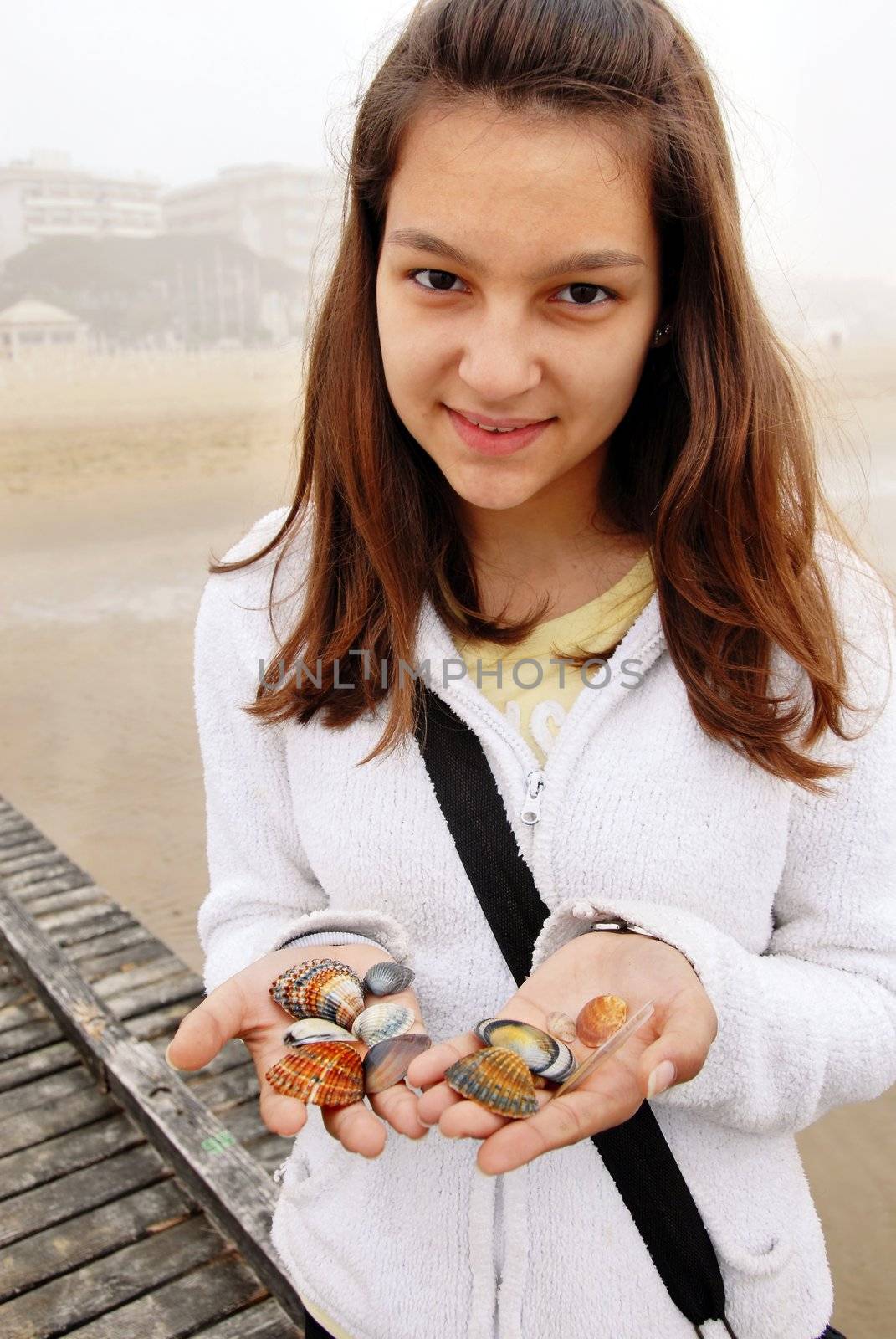 Teenage girl with shells by simply