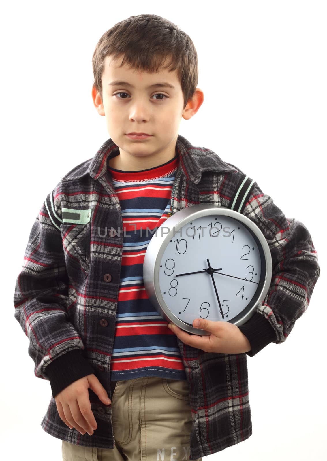 Portrait of a schoolboy with a clock. Time to school concept 