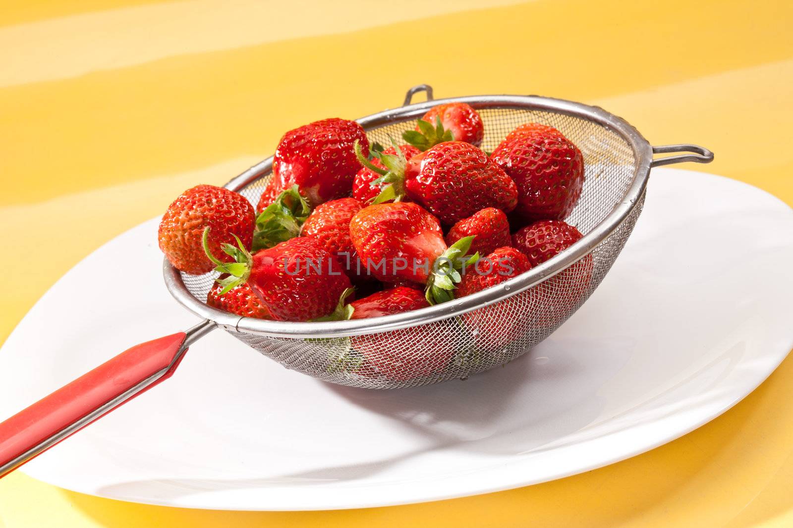 food series: red straberries in steel collander