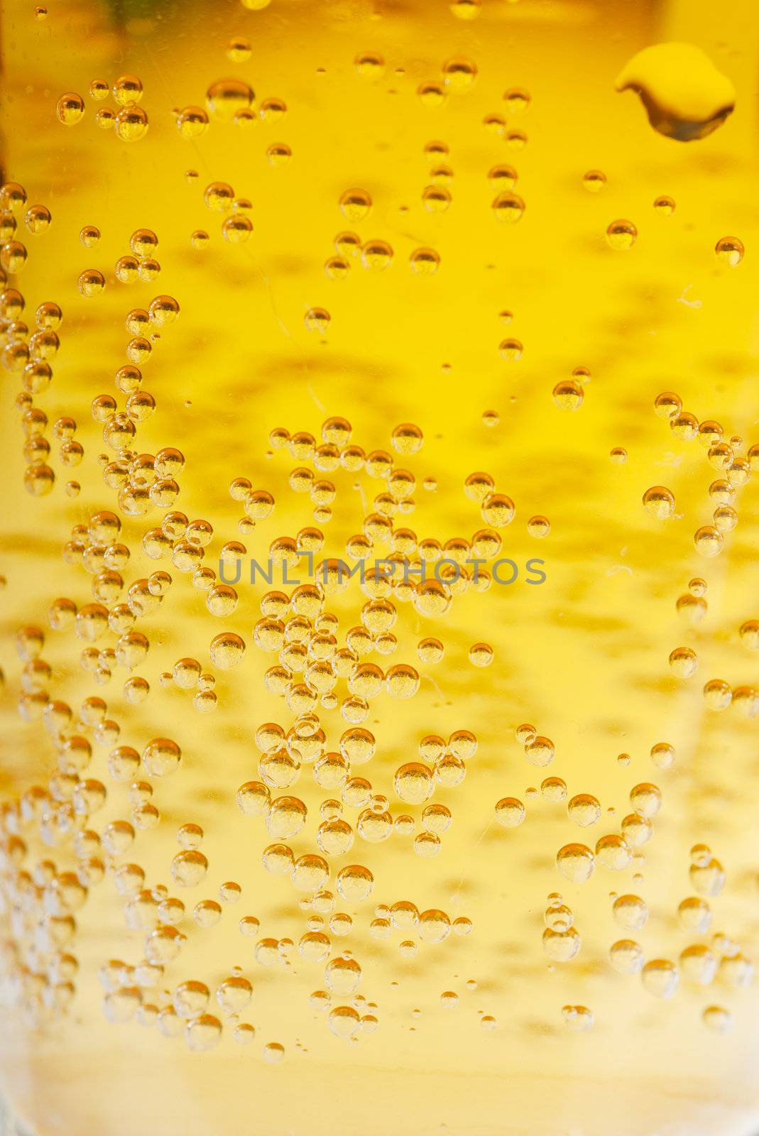 Orange beer with bubbles background. Closeup view.